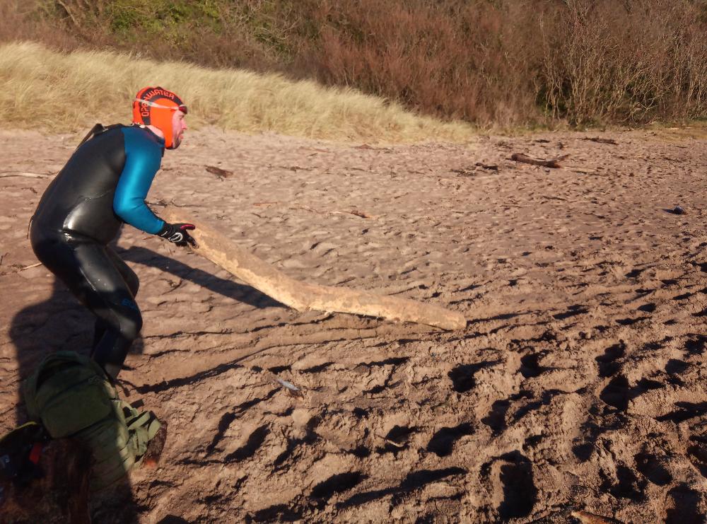 Lifting logs as part of Swim Pembrokeshire Neptune Steps training 2020